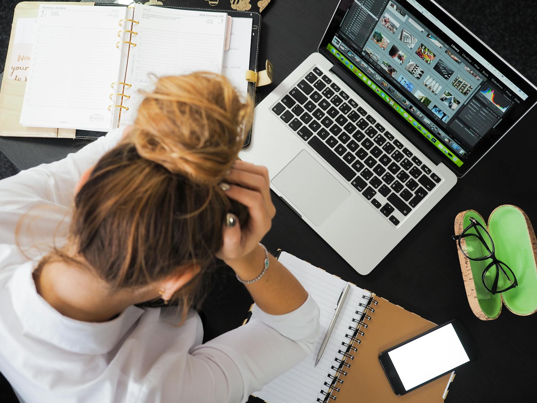 Woman troubleshooting on her laptop, representing the challenge of having no dedicated product or service pages — one of What Are the Top SEO Mistakes Small Businesses Make.