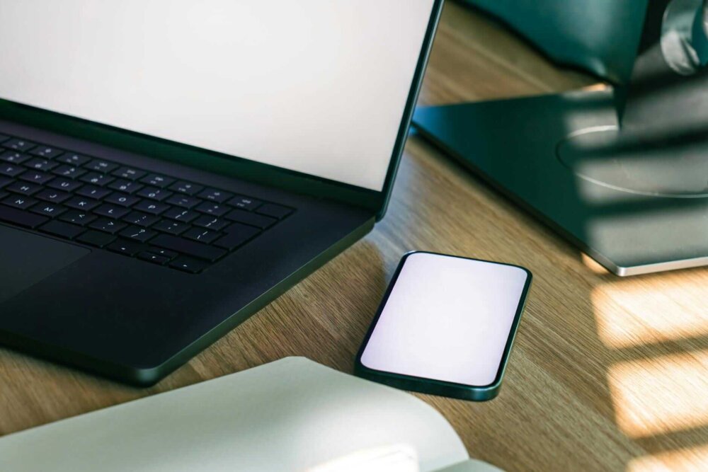 modern office workspace with laptop and smartphone