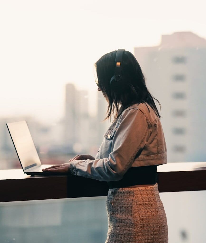 woman working on laptop in urban balcony