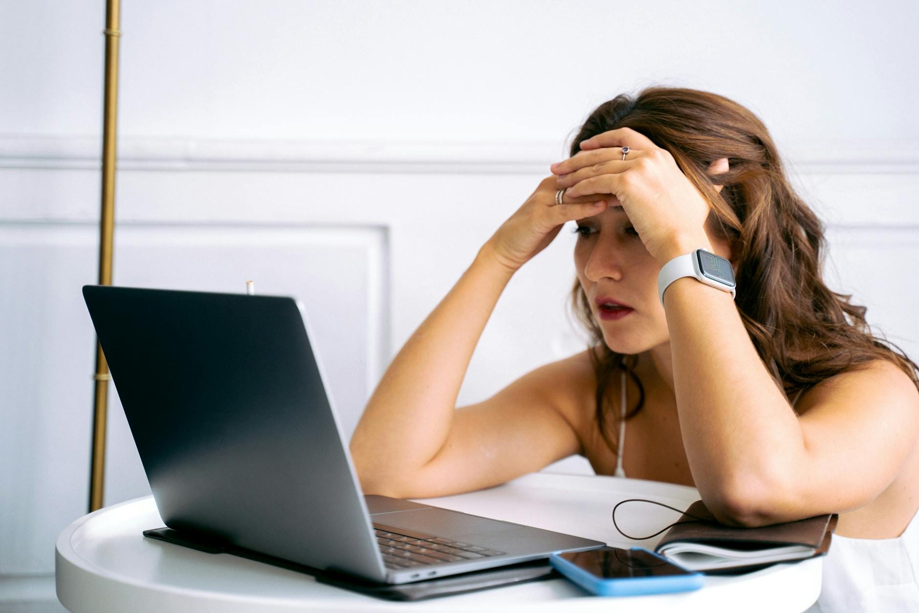 Exhausted woman working on a laptop, symbolizing the struggle of relying only on Instagram or TikTok for sales, which is one of What Are the Top SEO Mistakes Small Businesses Make
