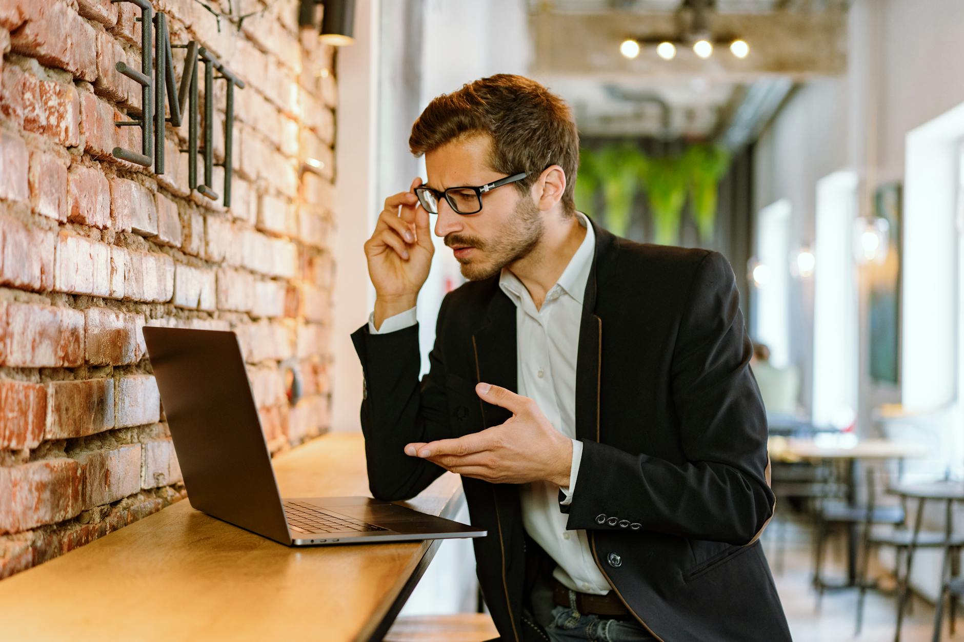 a man in black jacket using laptop