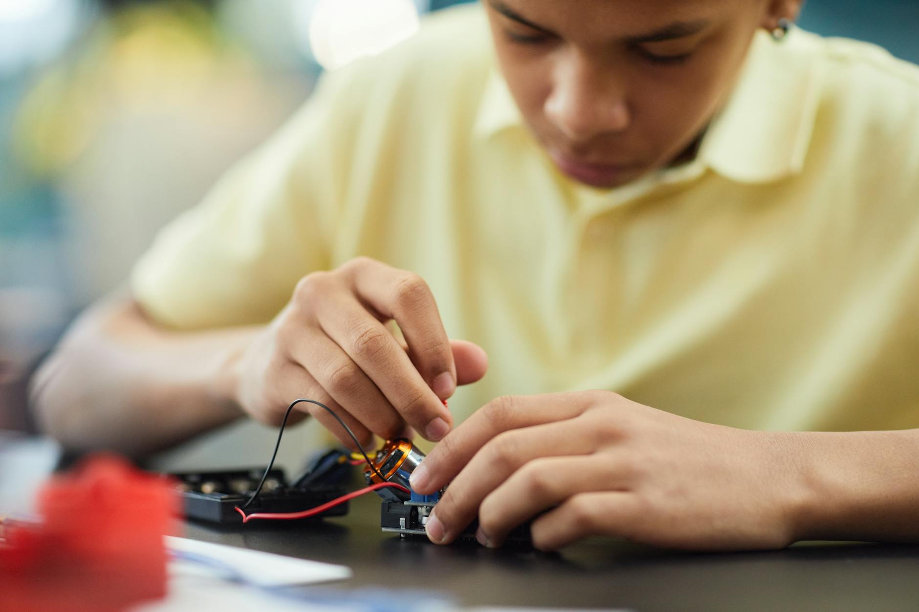 boy fixing an electronic device